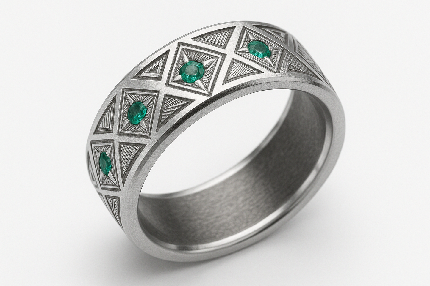 Thin angular silver ring with geometric engravings and emerald stones
