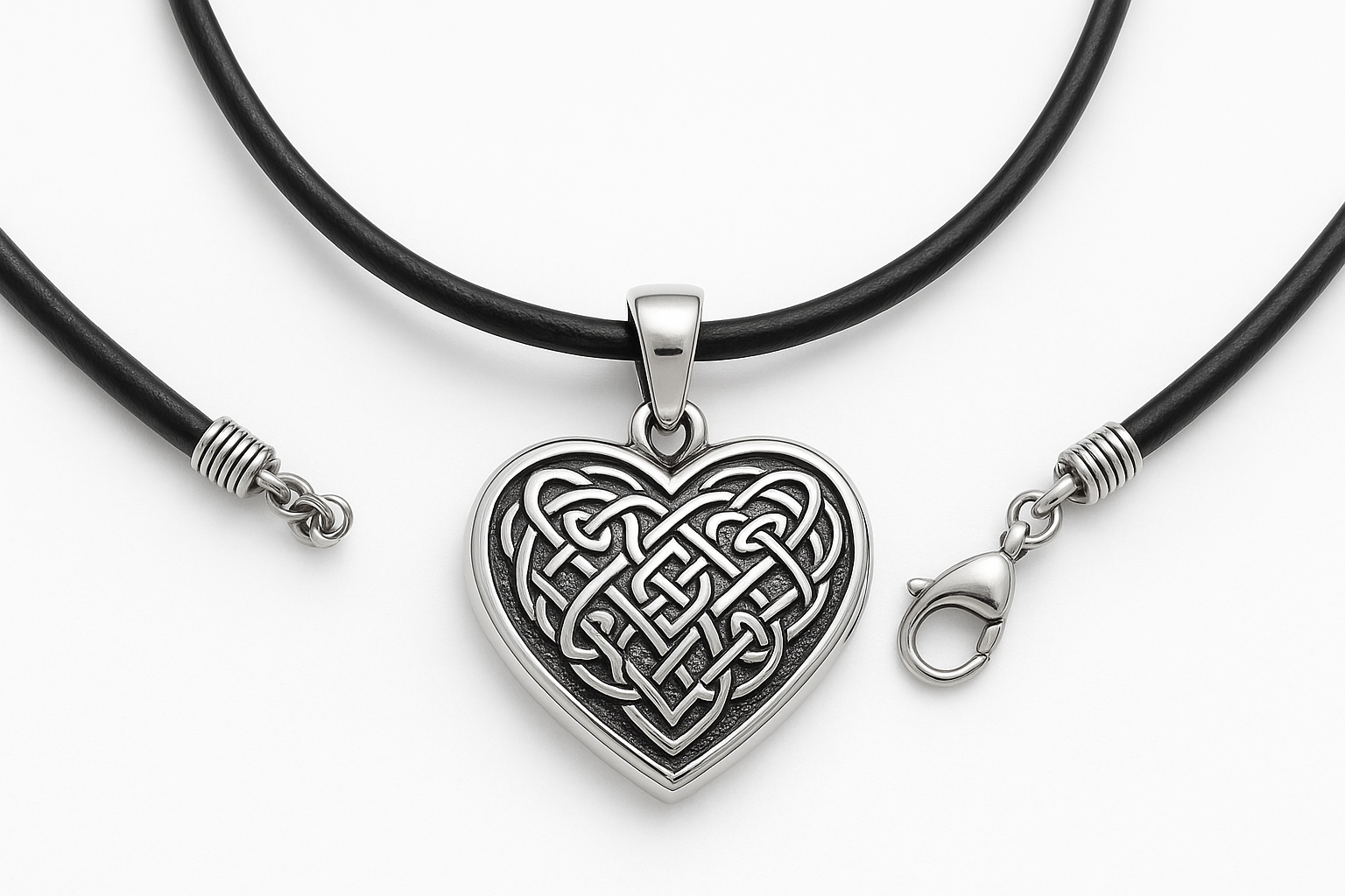 Heart-shaped silver pendant with Celtic knot engraving on black leather cord