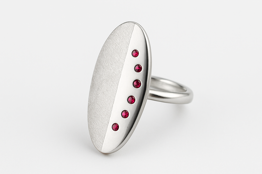 Oval silver ring with ruby stones