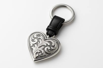 Silver heart-shaped keychain with black leather strap