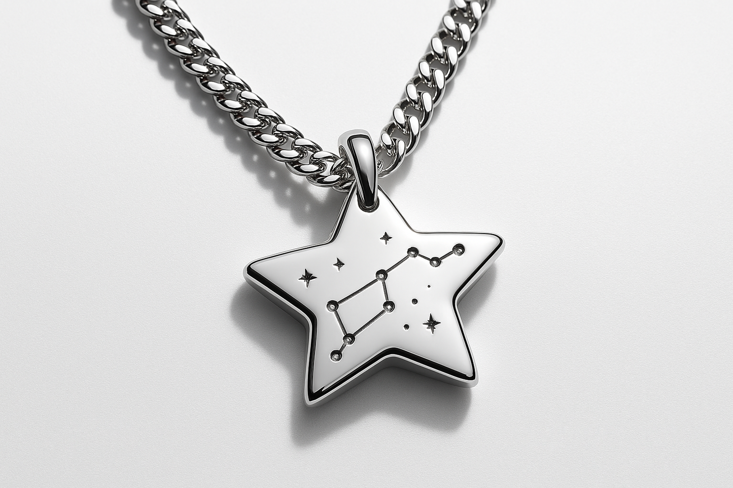 Star-shaped silver pendant with constellation engraving on silver curb chain
