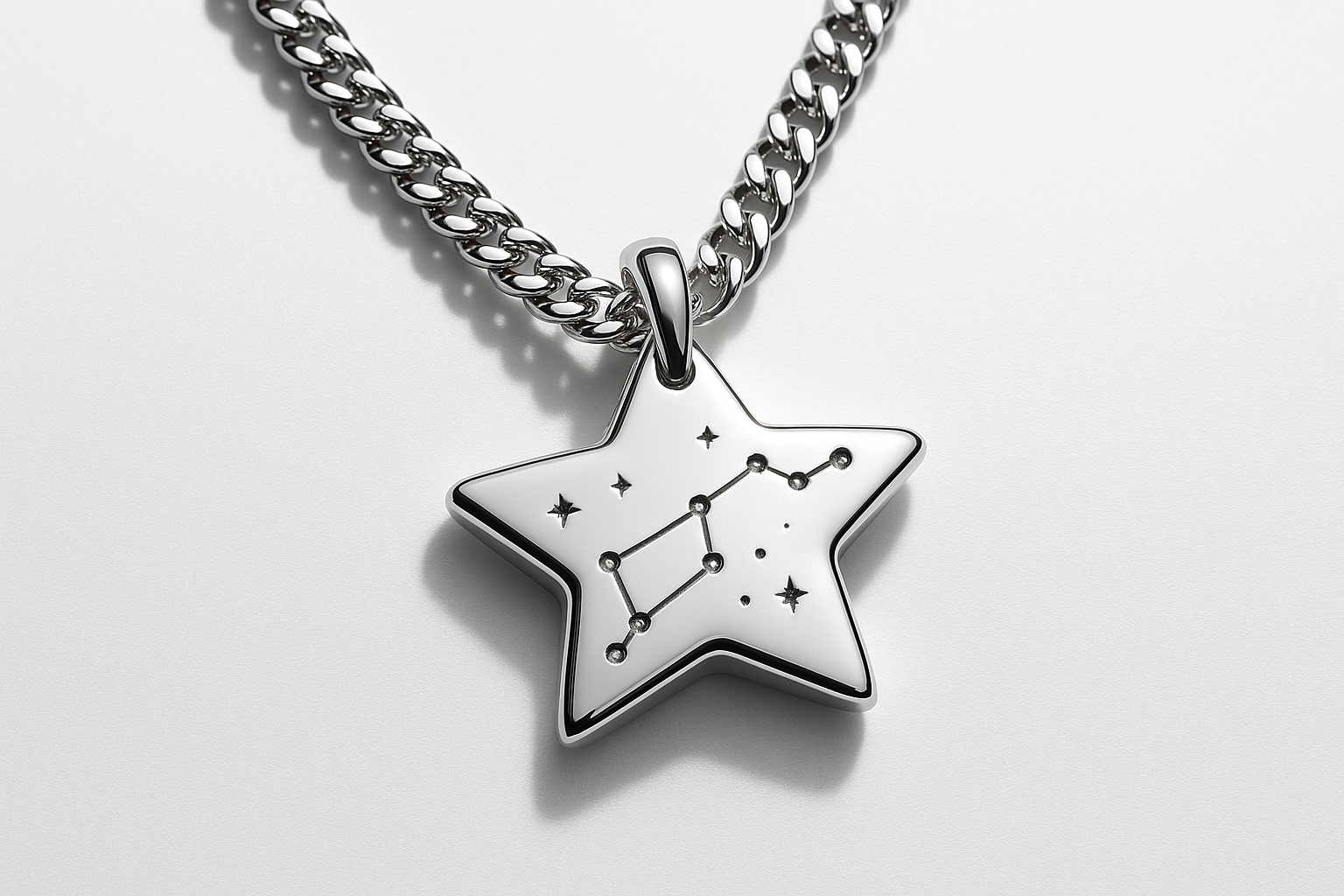 Star-shaped silver pendant with constellation engraving on silver curb chain