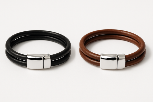 Two double row leather bracelets - black and brown with shiny silver clasps on white background